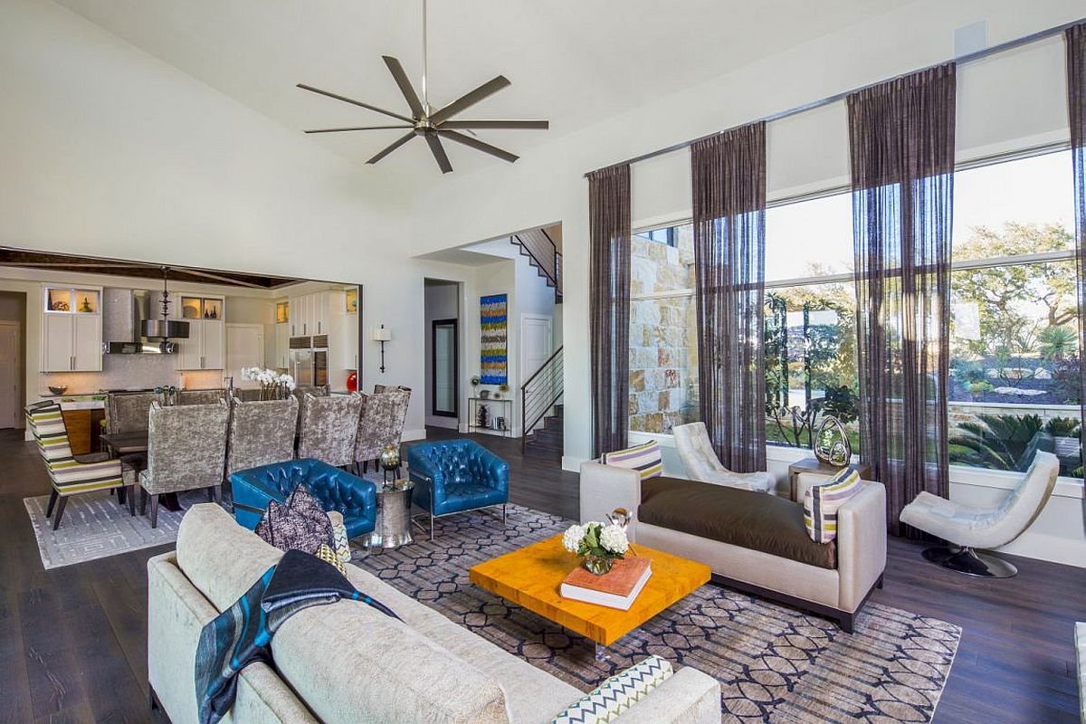 Spacious living room in neutral hues with pops of yellow and blue