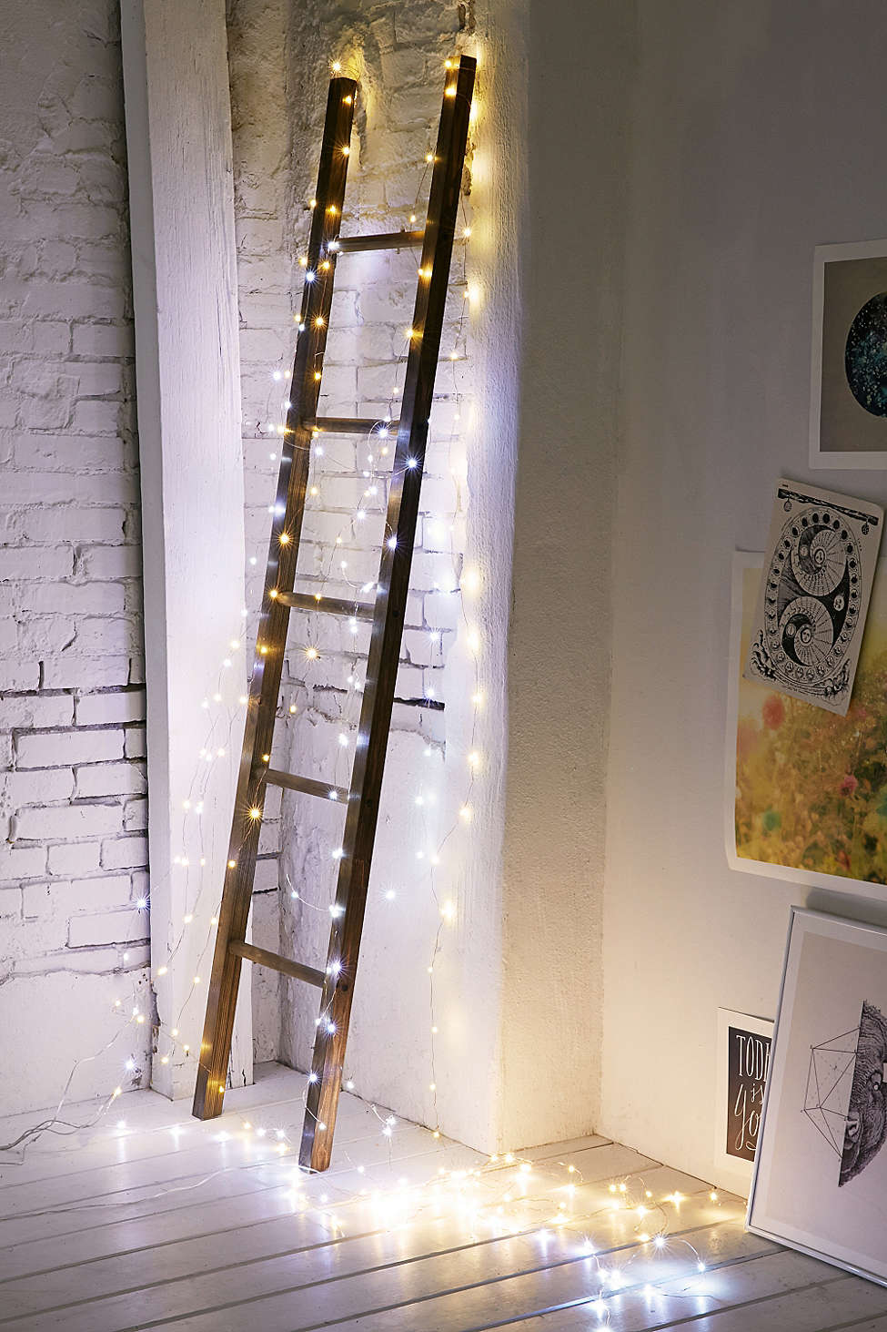 String lights illuminate a corner ladder