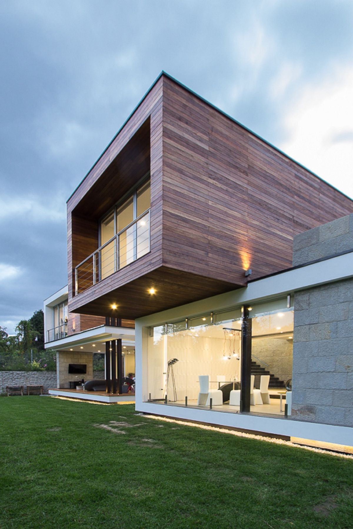 Top level of the house is draped in wood while the bottom structure is made from stone