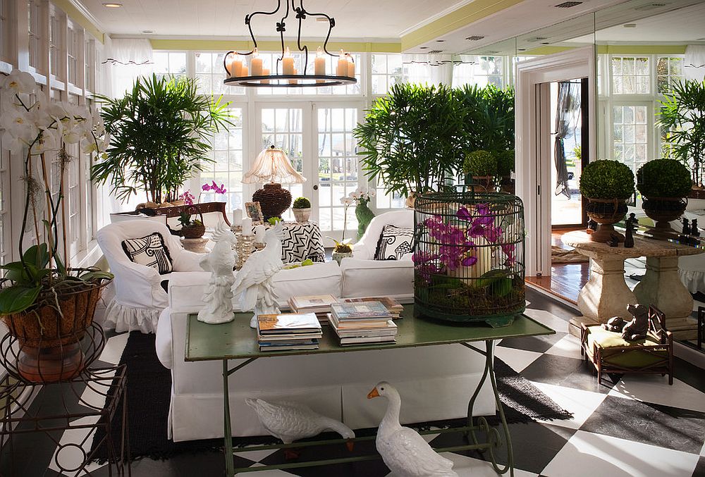 Tropical sunroom in white with plenty of greenery [Design: Patty Downing Interiors]