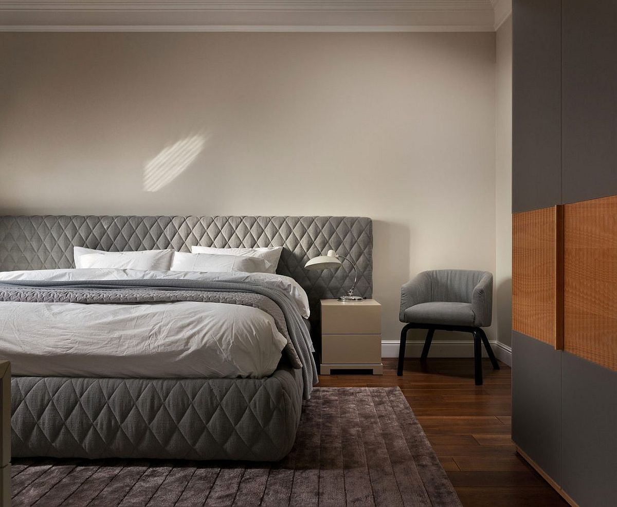 Tufted headboad for the large bed creates an air of luxury in the bedroom