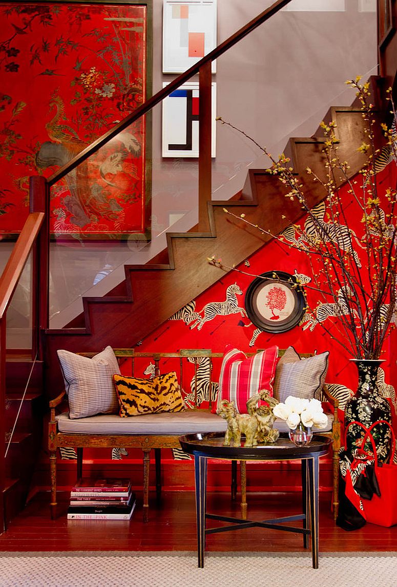 Vivacious zebra wallpaper in Masai Red for the small eclectic entry complements the stairway wall art [From: Bryant Keller Interiors / Rikki Snyder]