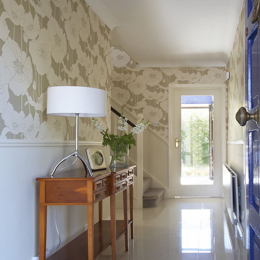 Wallpaper connects the traditional entry with hallway and the living room beyond