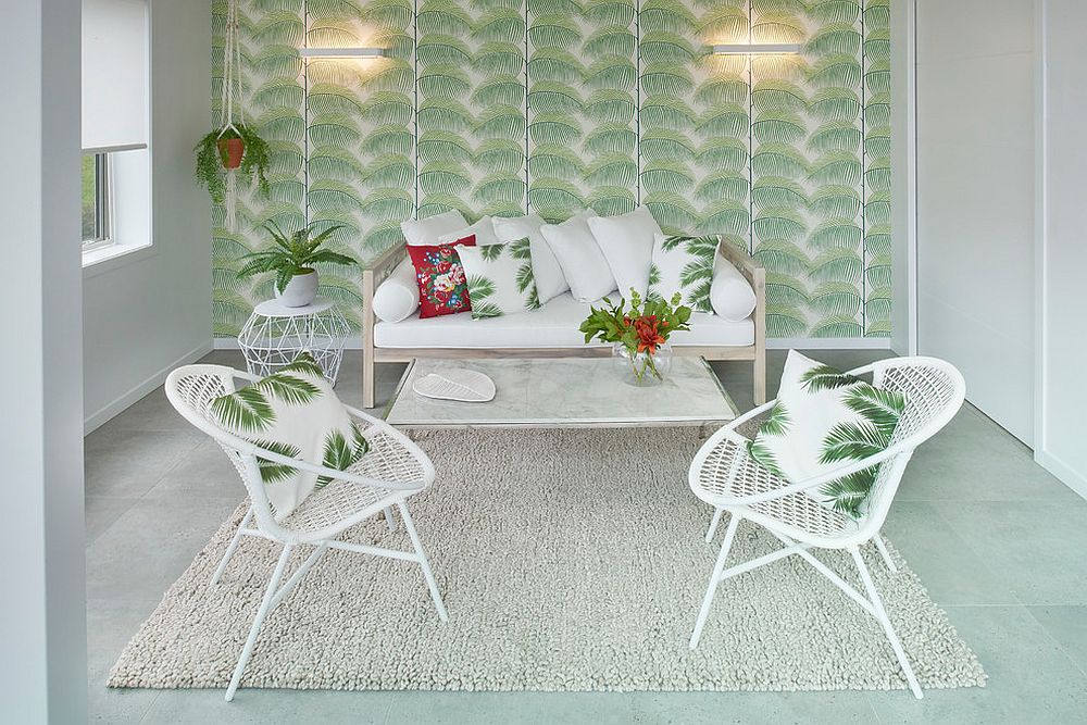 Wallpaper with bold tropical leaf motif creates the ideal backdrop for a relaxing sunroom