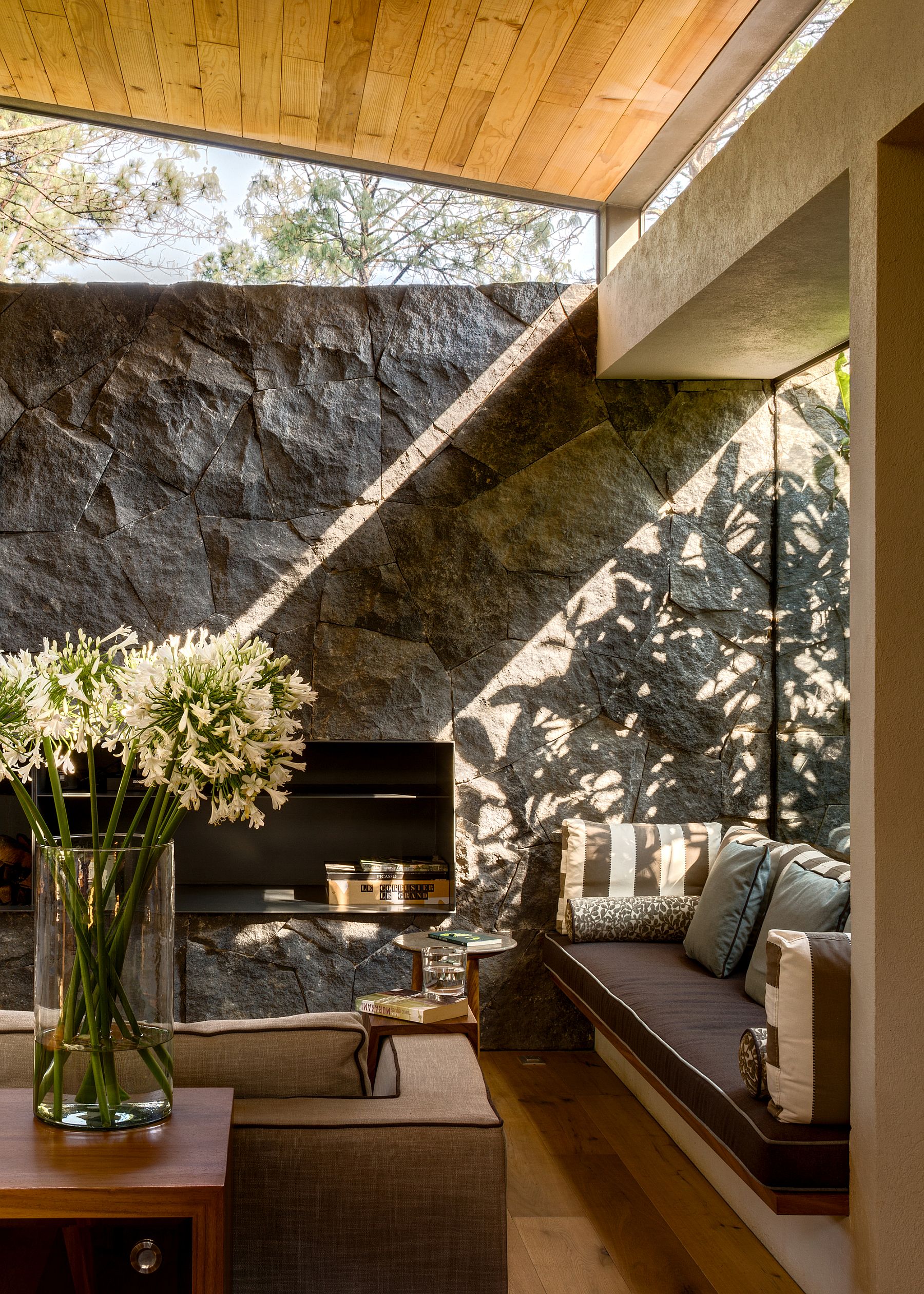 Window seat and natural stone wall inside the tranquil home