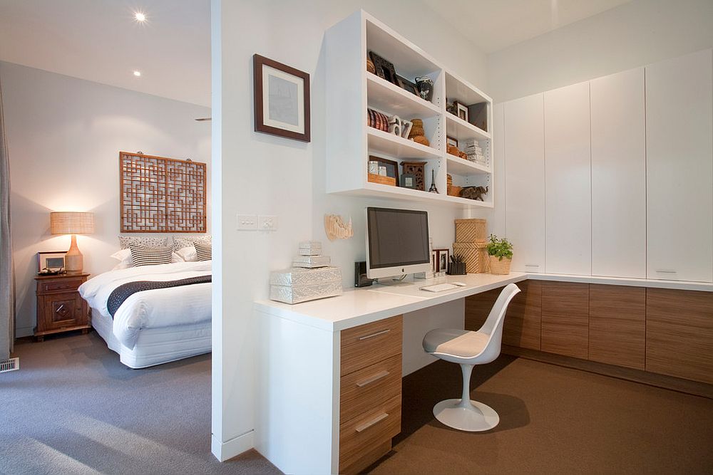 Wooden cabinets bring warmth to the home office in white next to the master bedroom [Design: Vibe Design Group / Photography by Travis De Clifford]