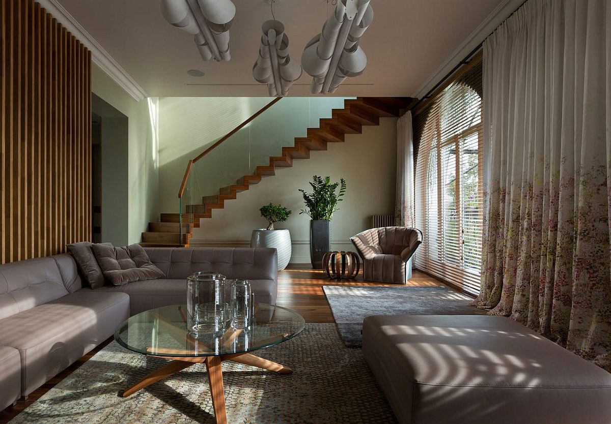 Wooden staircase with glass railing leads to the top level