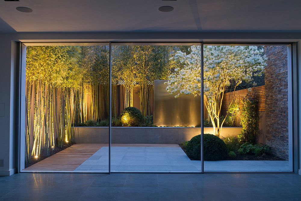 Bamboo, white flowers and a water feature turn this small garden into a showstopper