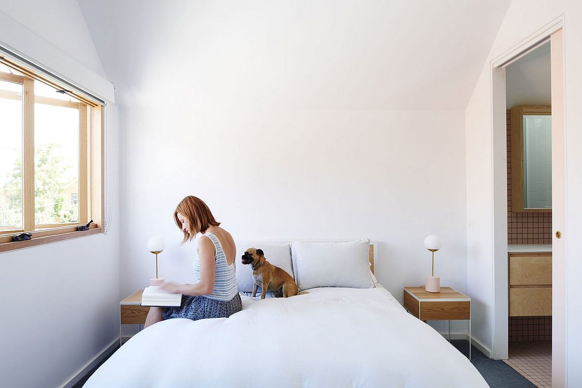 Bedside tables bring symmetry and style to the minimal white bedroom