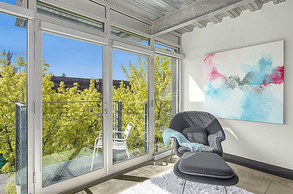 Bright and cheerful industrial sunroom with small balcony next to it