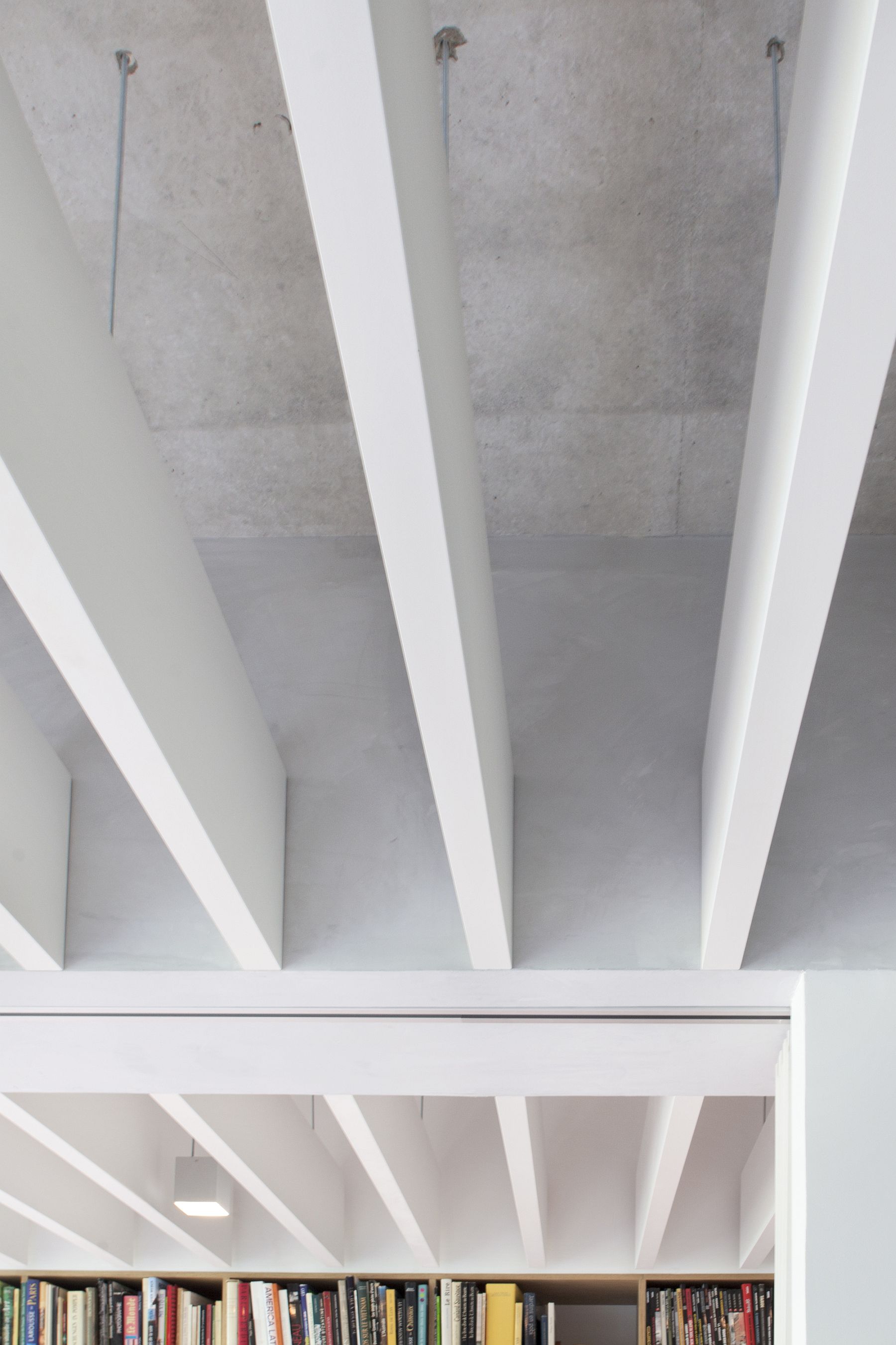 Concrete and wooden slats-made false ceiling inside the apartment