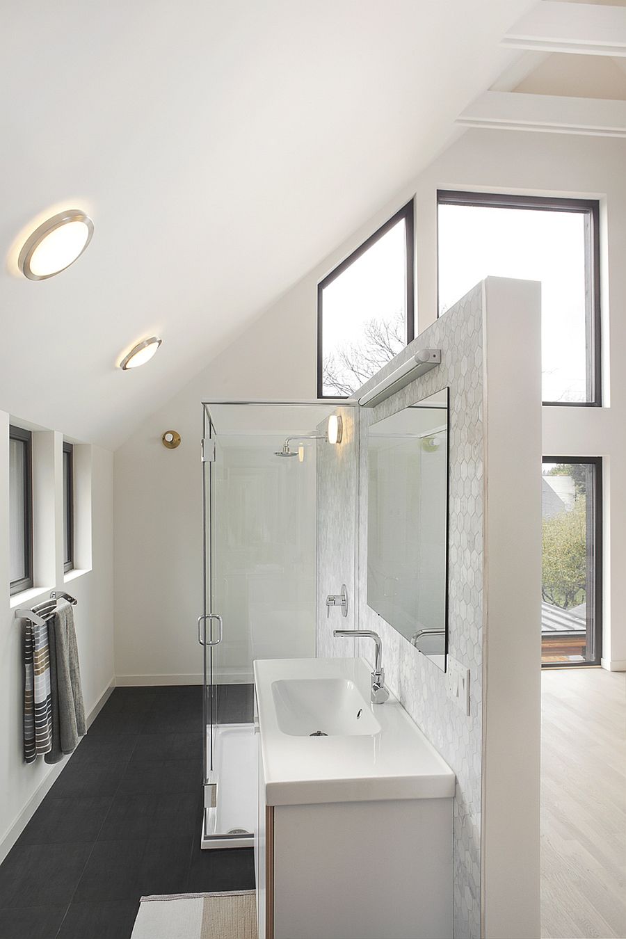 Contemporary bathroom in white has a spacious and cheerful appeal