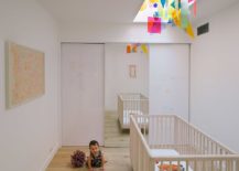 Contemporary-nursery-with-colorful-fixture-above-the-crib-217x155