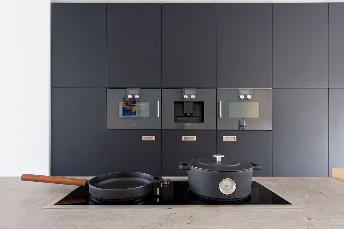 Dark wall of cabinets and appliances in the kitchen