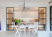 Dining-area-and-kitchen-seperated-by-framed-glass-partitions-with-industrial-style-217x155
