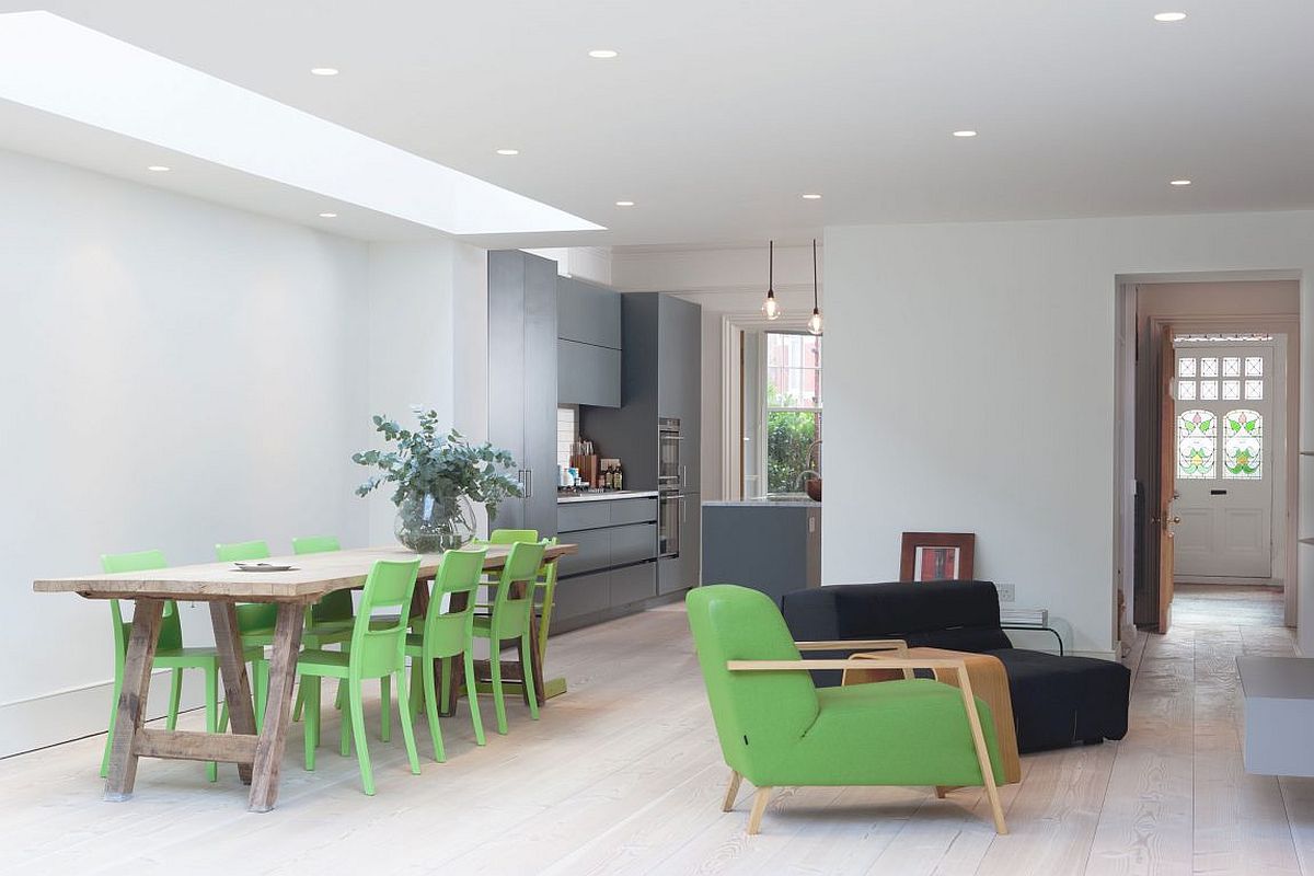 Dining table chairs and club chair give the interior a green glint