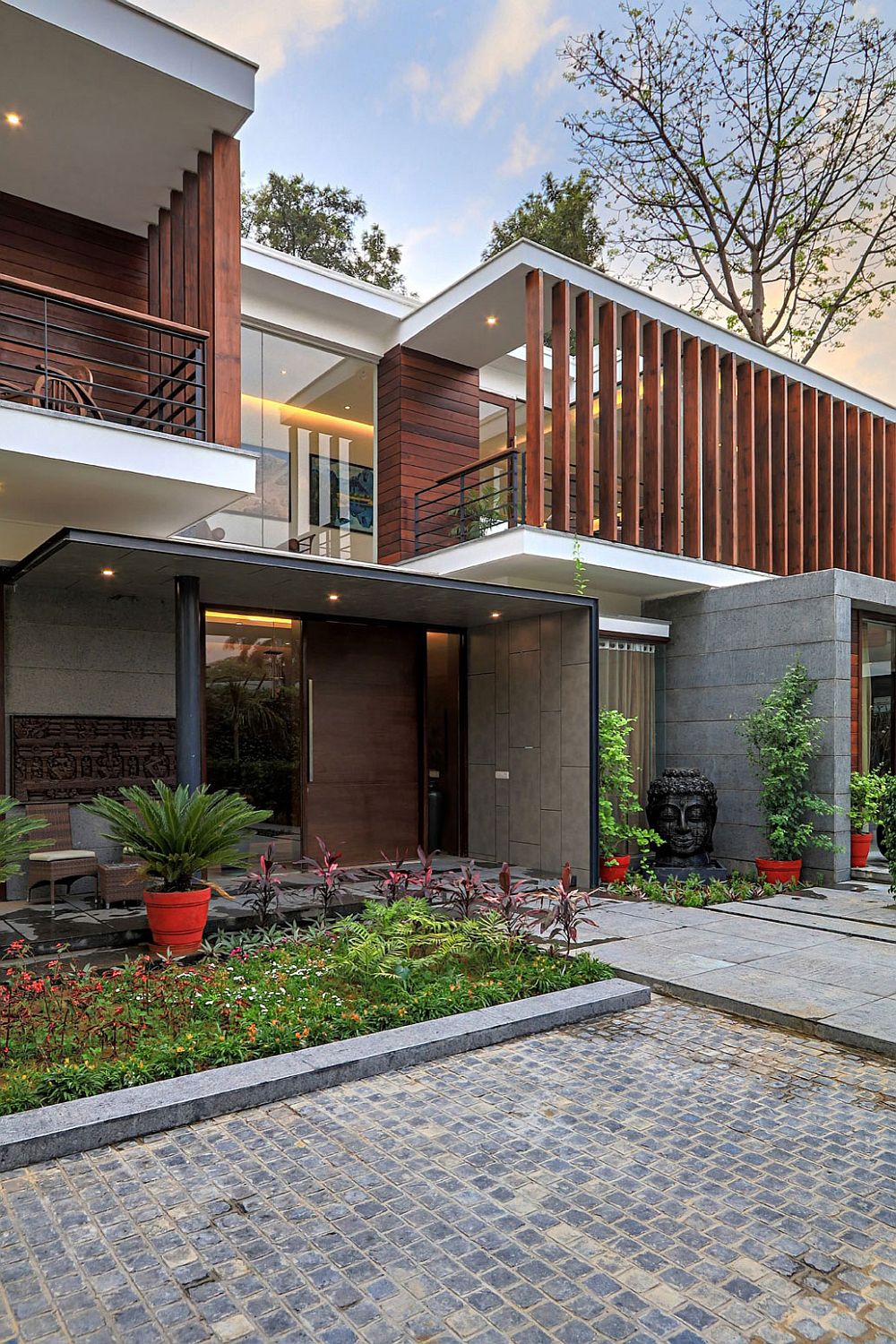 Entrance to the modern house combines Indian design with western style