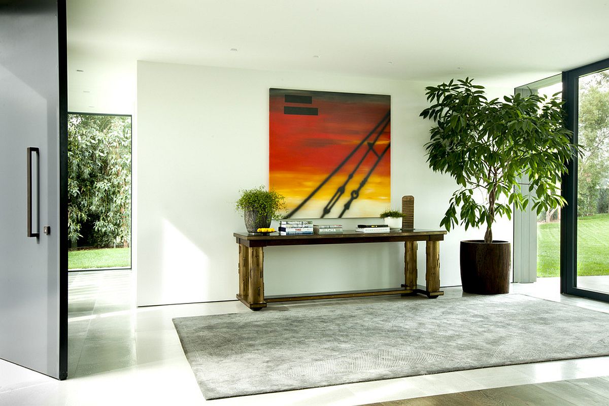 Entry design idea with a cool table and art work above