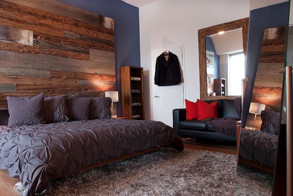 Exquisite bedroom of Philadelphia penthouse with accent wall crafted from three different types of reclaimed wood