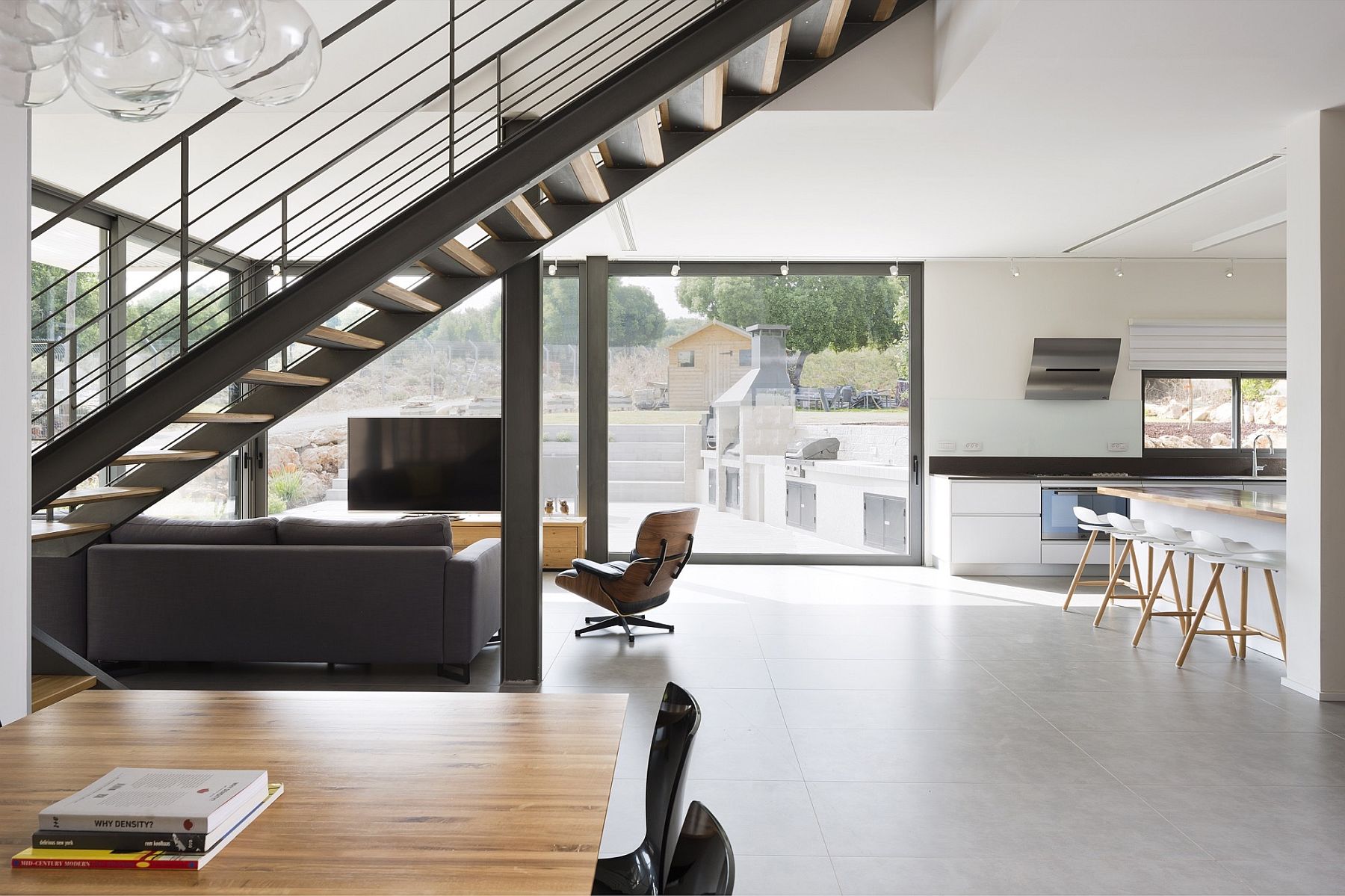 Exquisite metallic staircase connects the living area level with the master bedroom above