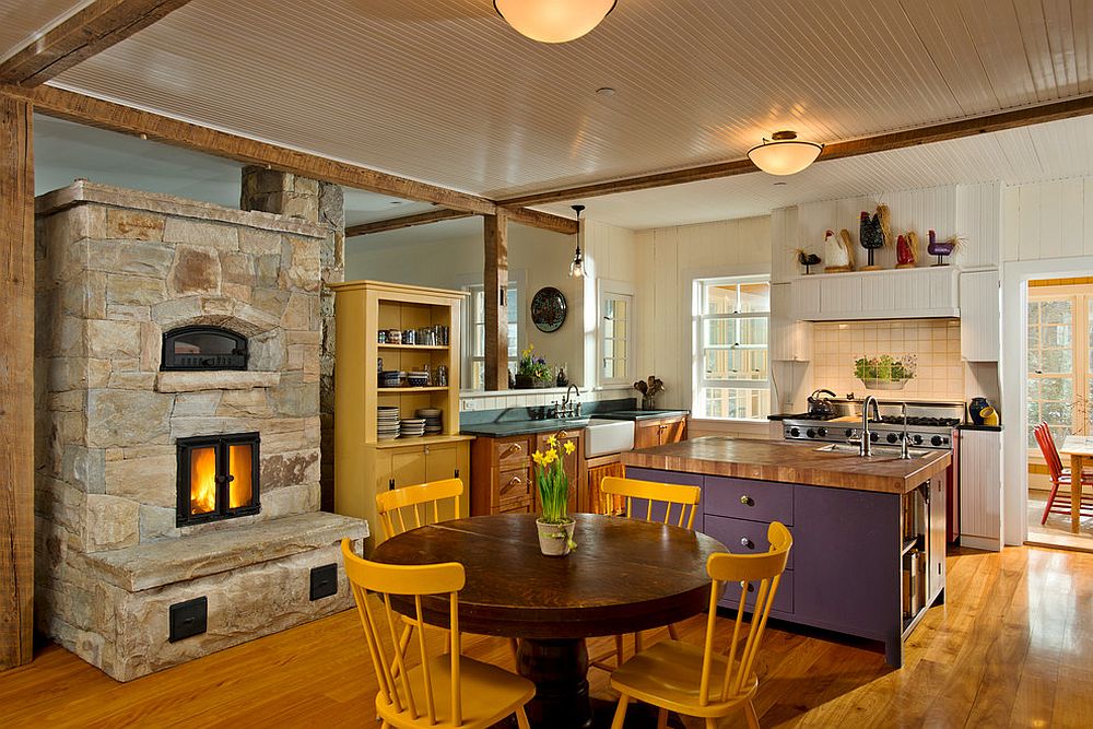 Farmhouse style kitchen of New York home with colorful decor and a lovely stone fireplace