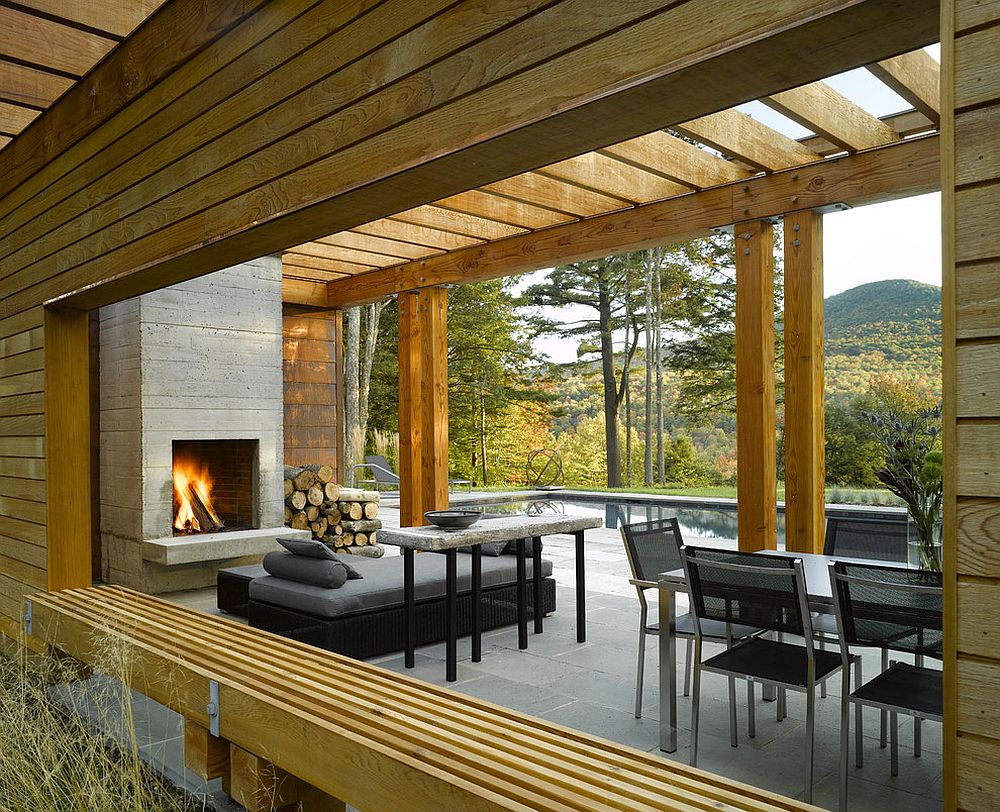 Fireplace and smart seating inside the contemporary pool house [Design: Wagner Hodgson]