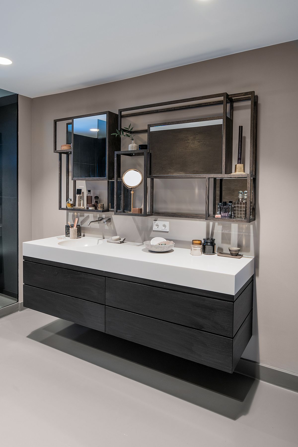 Floating vanity with smart shelving above it is the showstopper in this sleek contemporary bathroom