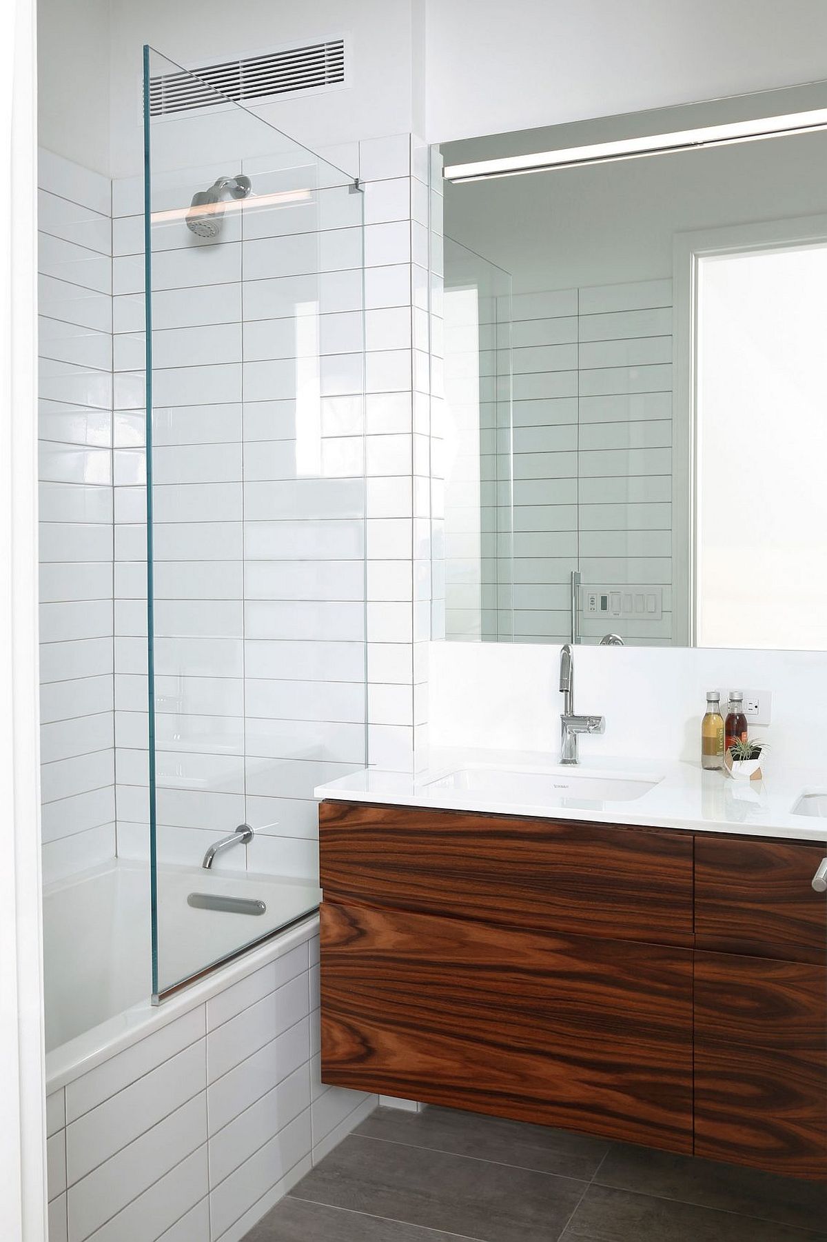 Floating wooden vanity with polished countertop in the bathroom