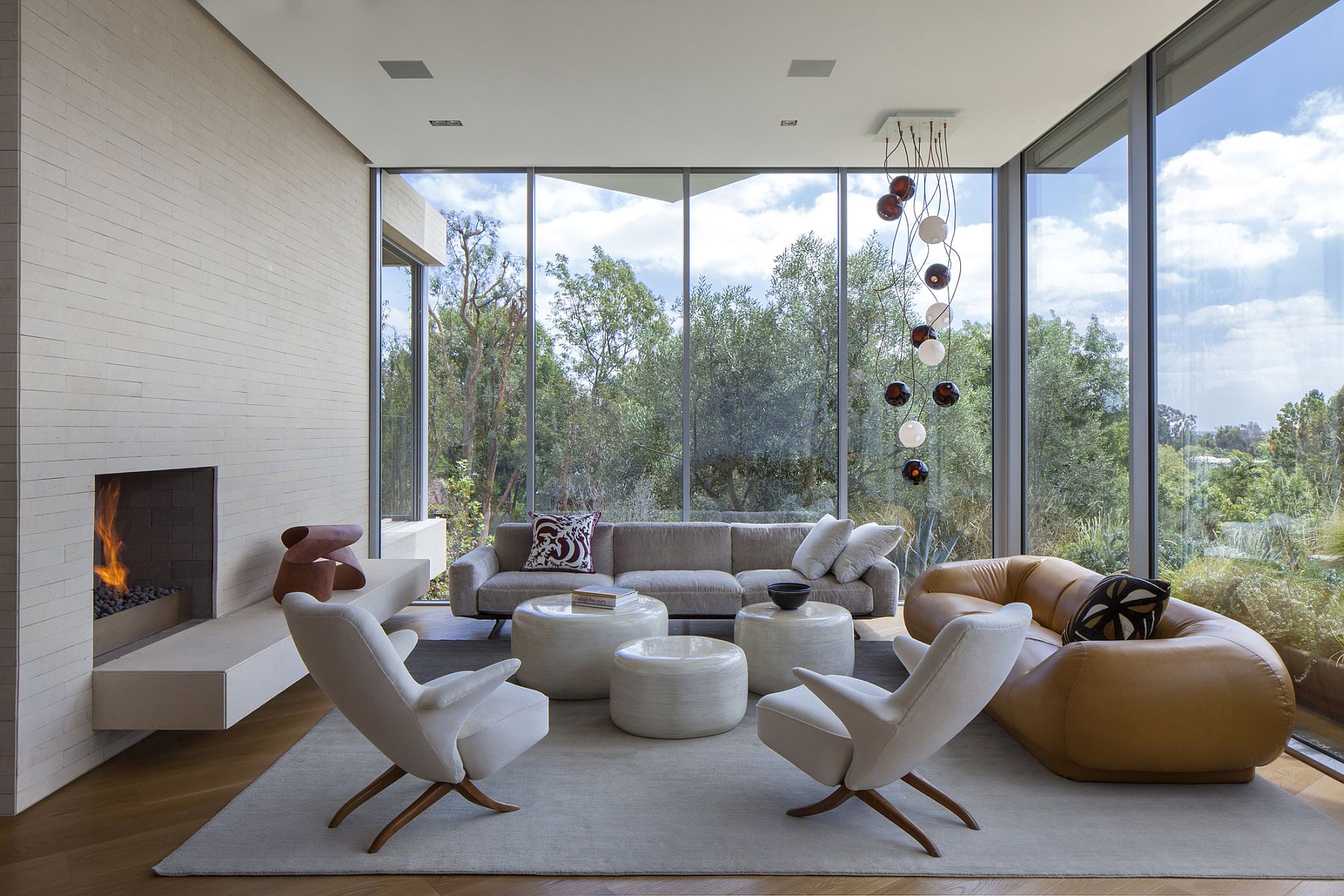 Floor-to-ceiling glass walls offer unabated views of the green valley below