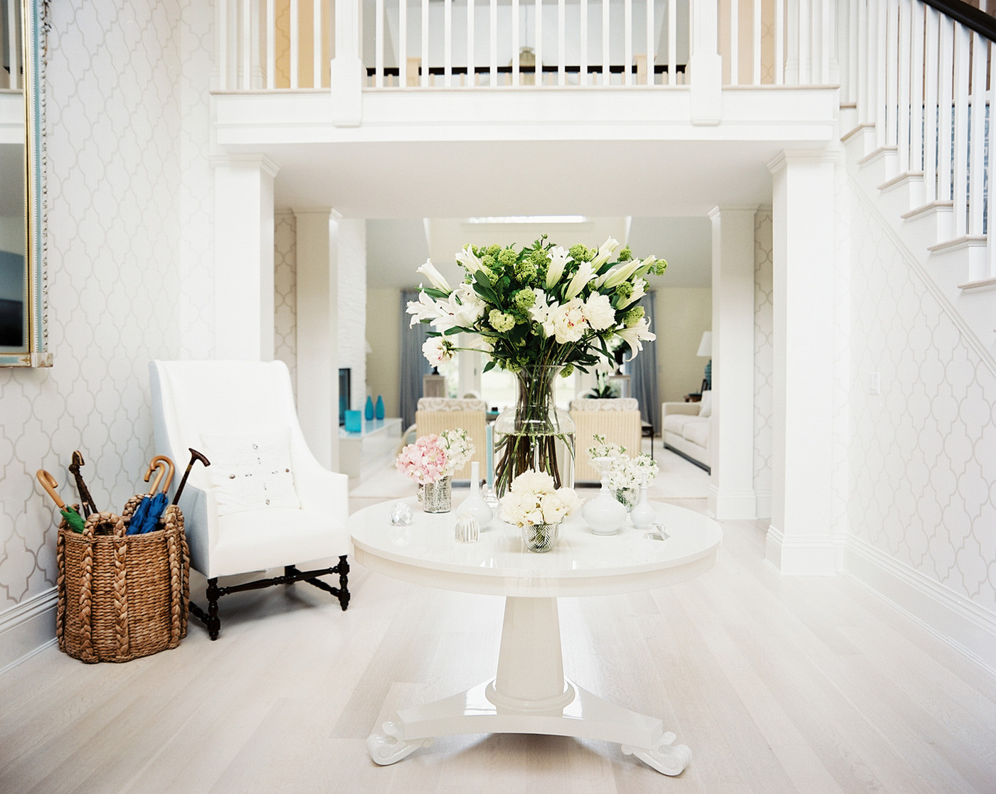 Foyer table with floral arrangements via Lonny