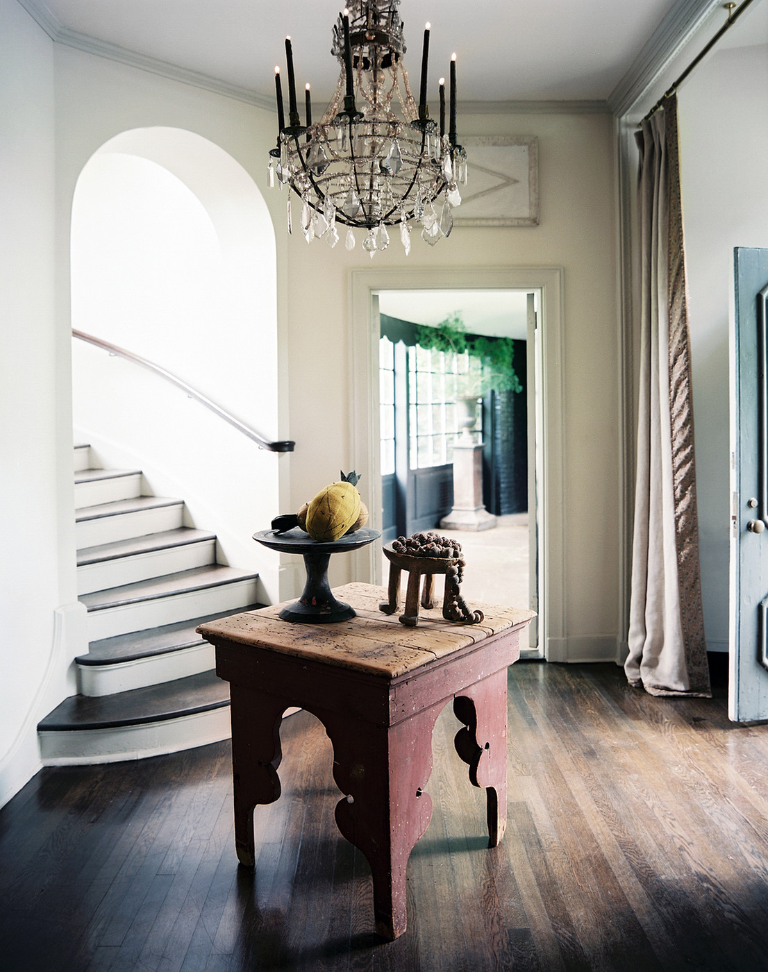 Foyer with a chandelier via Lonny