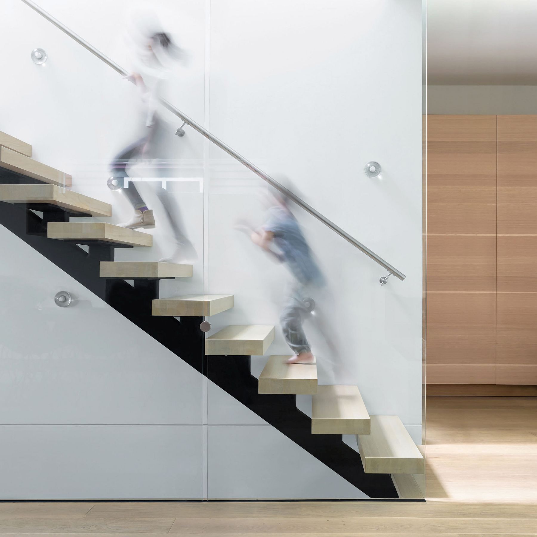 Glass balustrade and floating risers create a fabulous, sculptural stairway