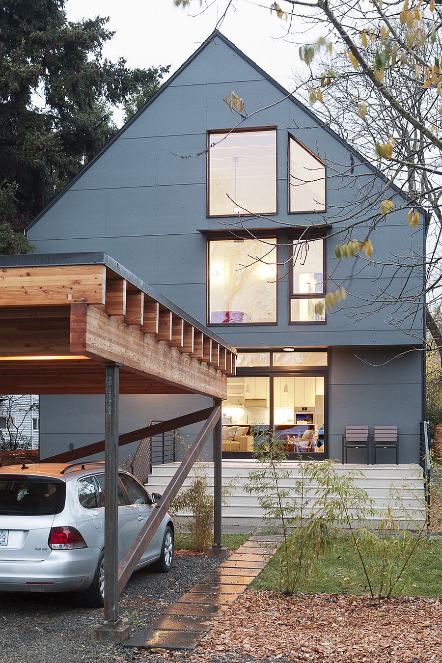 Gray exterior of the modern home with green design