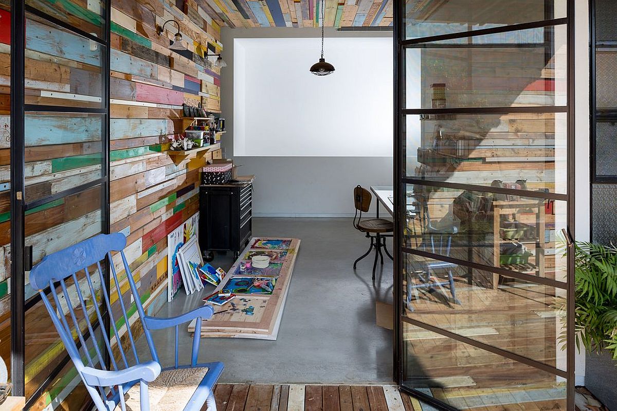 Home studio with color reclaimed wood wall