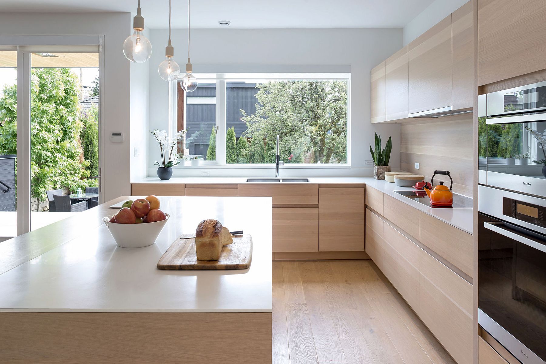 Kitchen that overlooks deck and garden outside