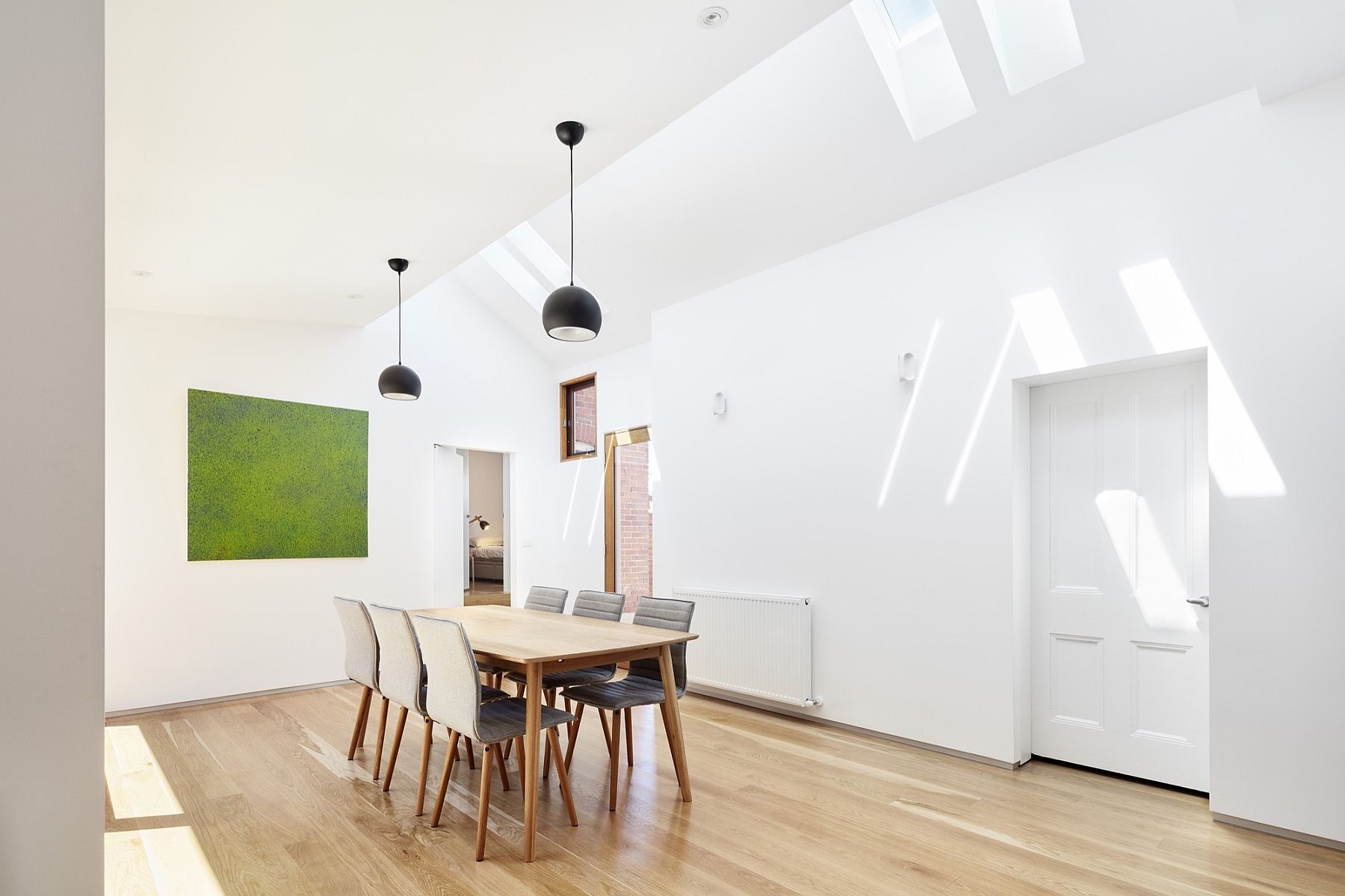 Large, sweeping dining room with skylights