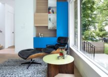 Living-area-with-the-classic-Eames-Lounger-and-colorful-modular-shelving-217x155