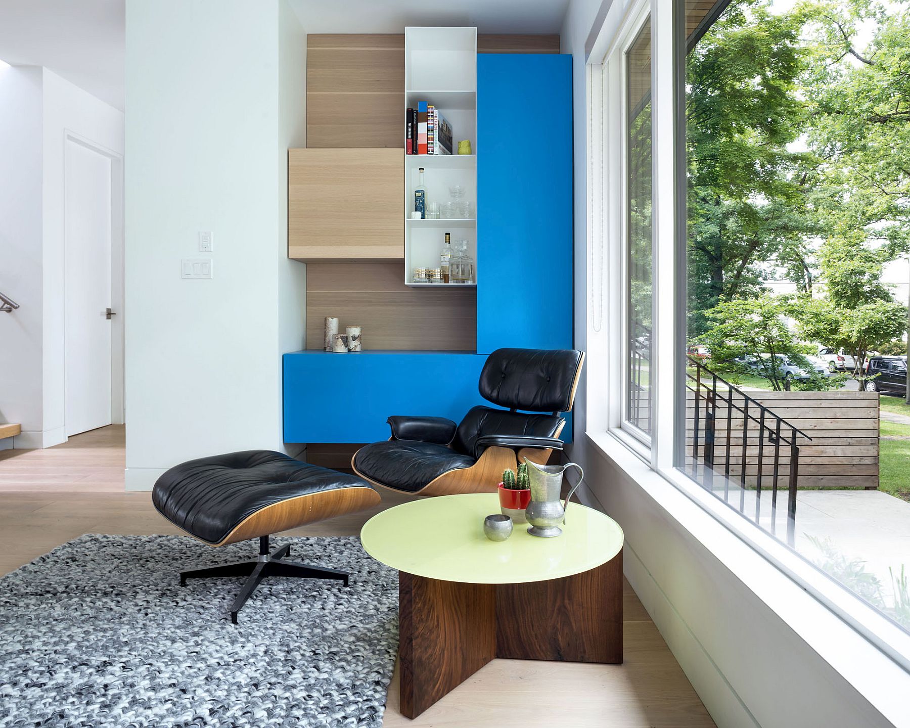 Living area with the classic Eames Lounger and colorful modular shelving