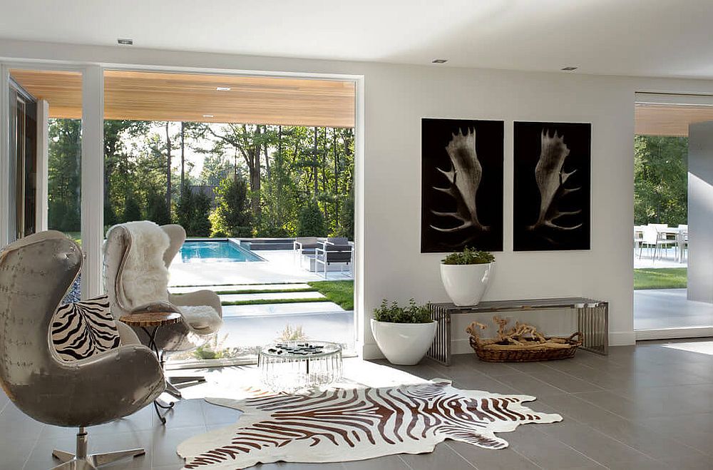 Living room of the Massachusetts home connected with the pool and garden outside