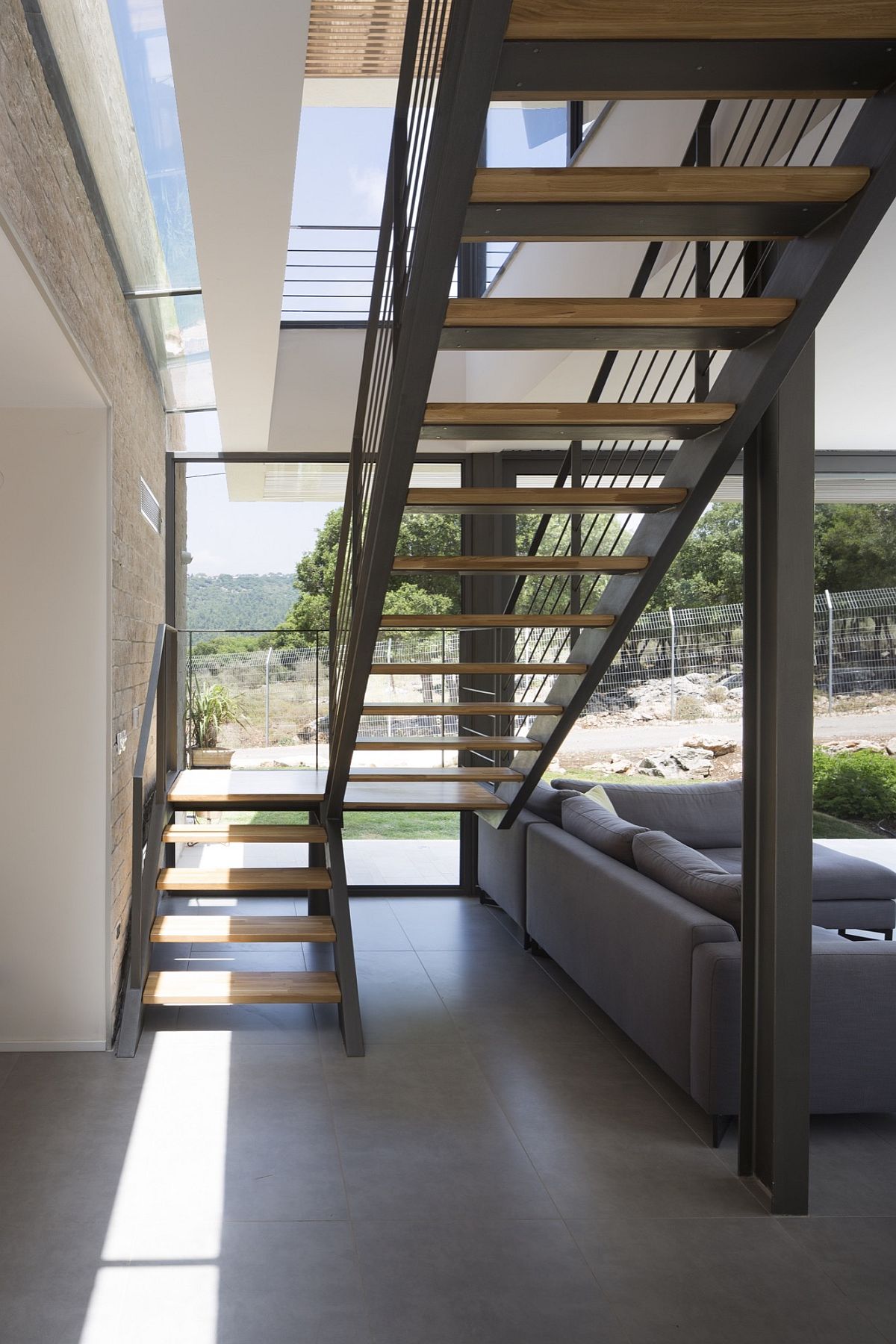 Metallic staircase gives the interior an edgy contemporary vibe