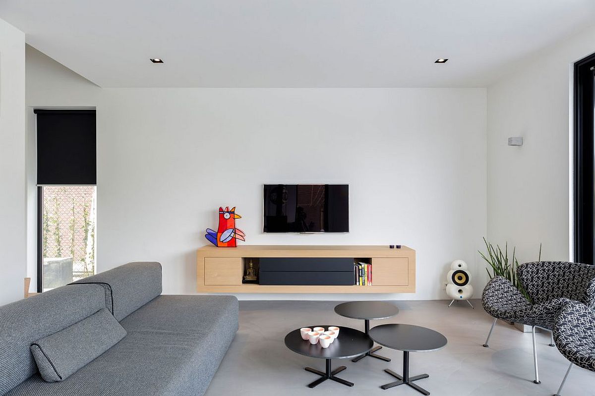 Minimal living area with gray couch and entertainment unit