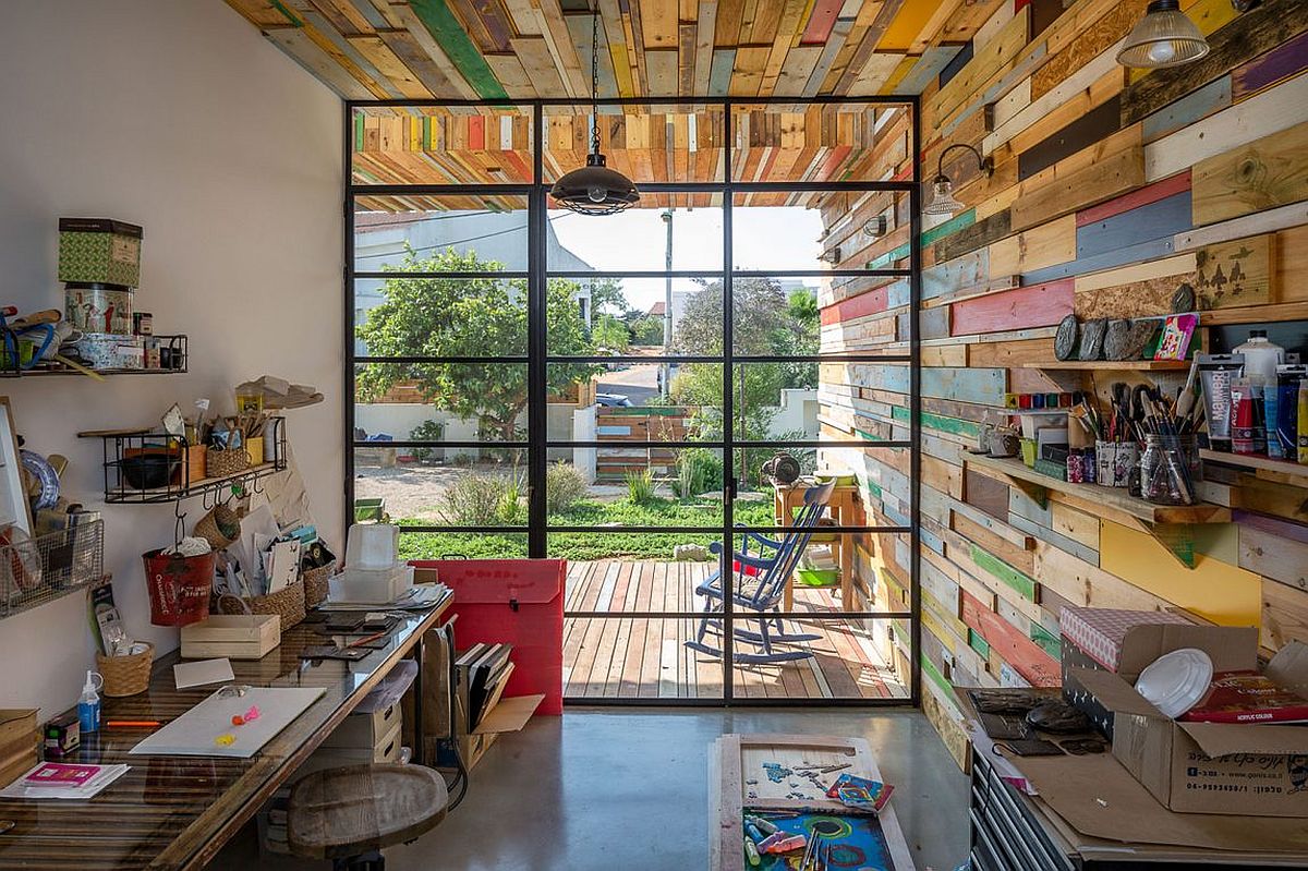 Modern industrial studio with large window and reclaimed wood walls