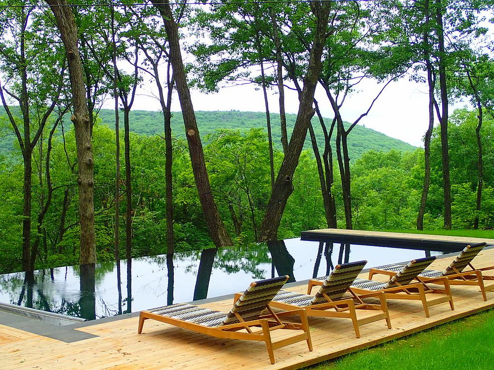 Modern pool and deck overlook mountains and the lush green forest [Design: NeJame Pool Specialists]