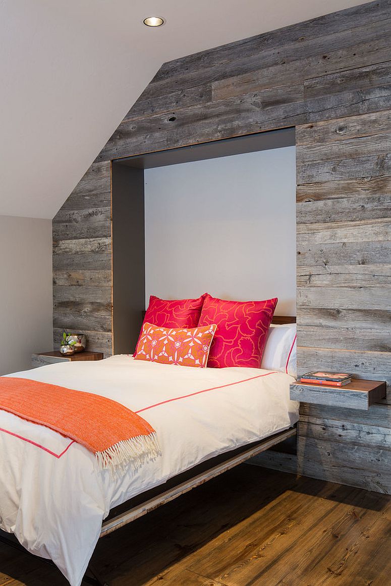 Murphy bed and pull-out nightstands disappear into the reclaimed wood wall when not needed