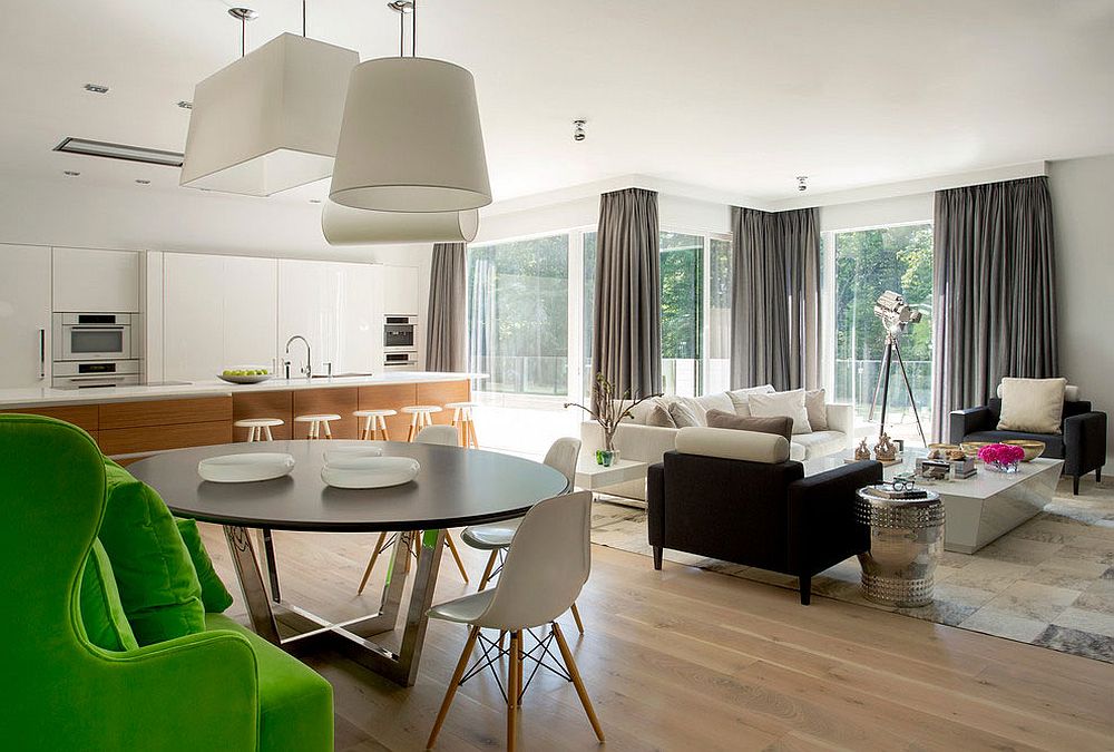 Open plan living area with kitchen in white and a wooden island