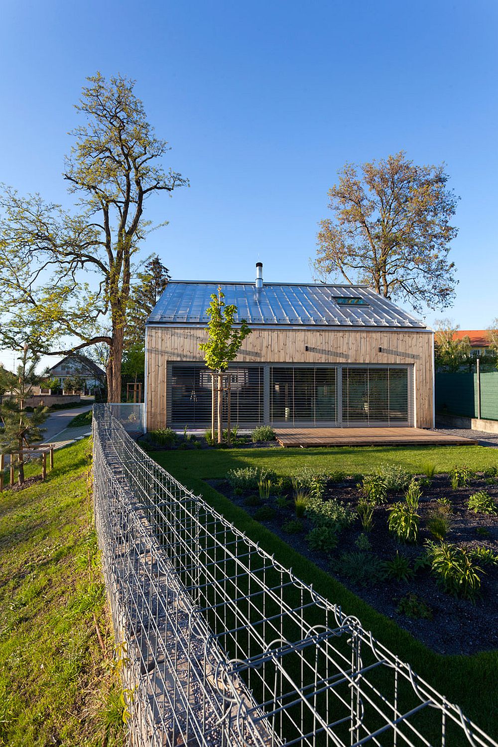 Private garden of the modern home with a wooden deck