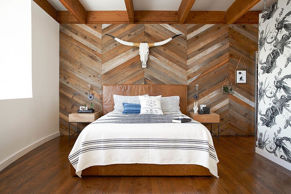 Reclaimed wood wall with chevron pattern steals the show in this bedroom