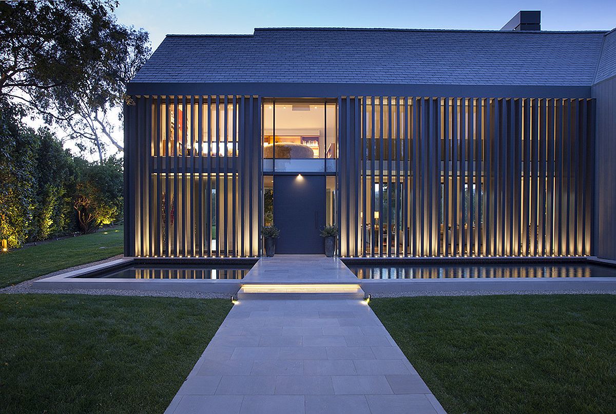 Reflecting pond and bridge create a stunning entrance at the revamped LA home