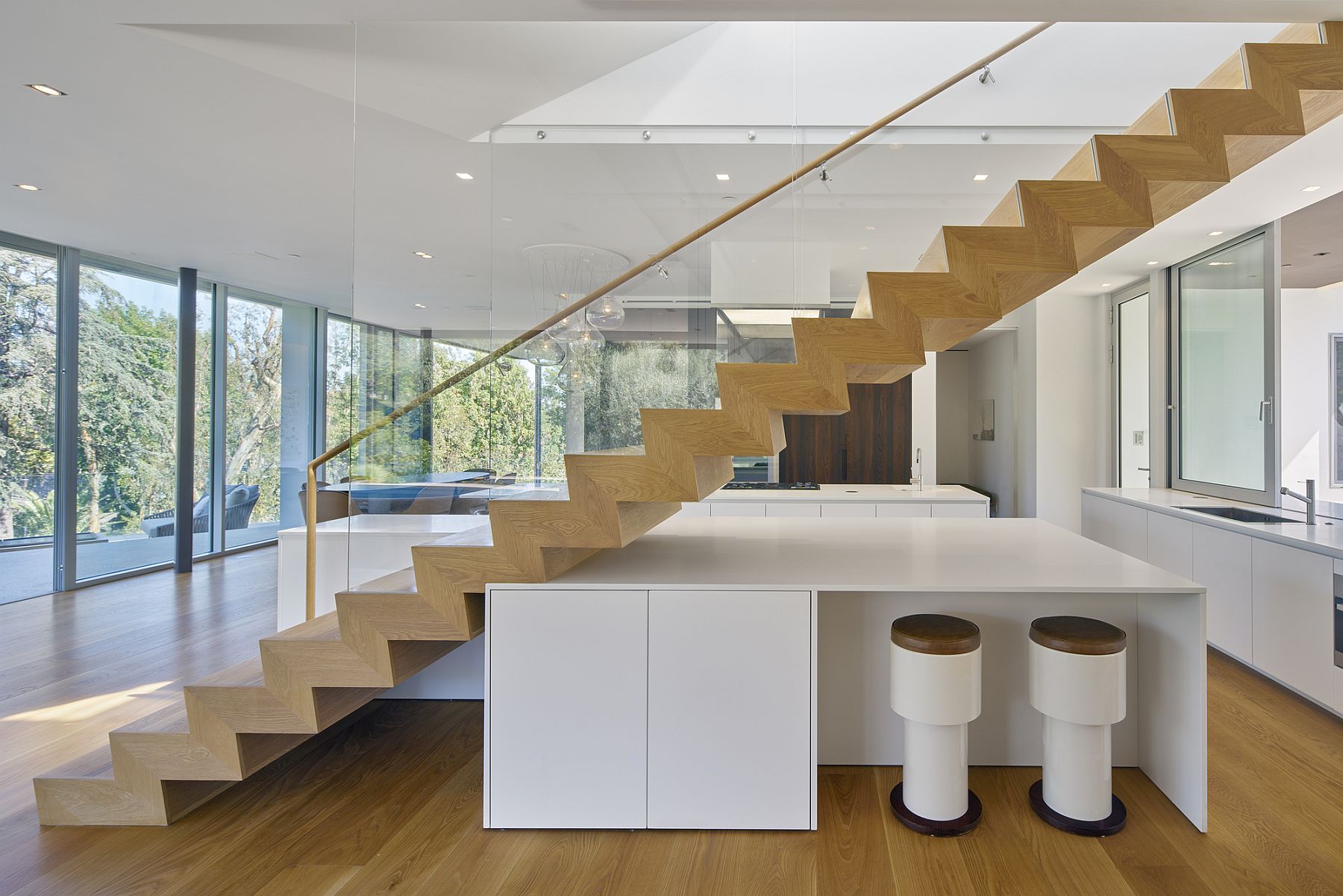 Sculptural staircase with smart island and breakfast zone underneath