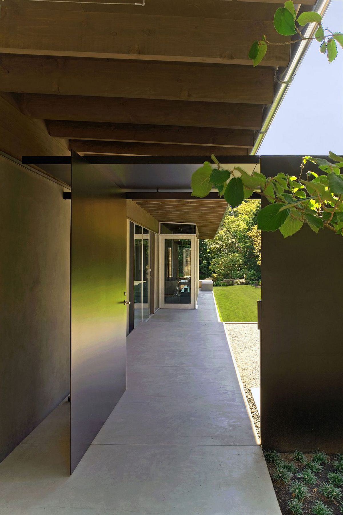 Sheltered terraces and outdoor spaces connect the interior with the lush green landscape around it